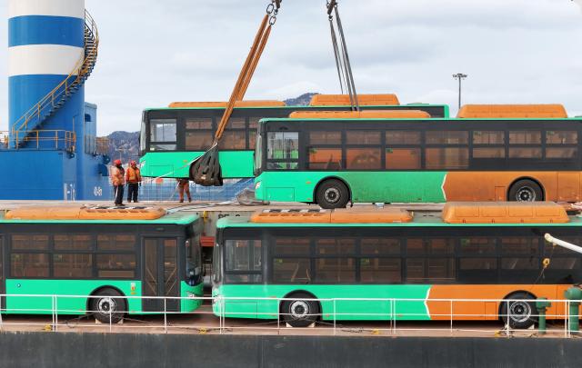 A ship is loaded with natural gas-powered buses, bound for Mexico, at the port in Yantai, in China’s eastern Shandong province on February 6, 2026. (Photo by AFP) / China OUT