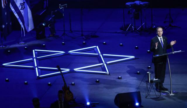 Israeli President Isaac Herzog delivers a speech as he participates in an event titled 'An Evening of Light & Solidarity' for the victims of the December 14, 2025 gun attack in Sydney on February 9, 2026. Herzog said February 9 people of all faiths will "overcome this evil" as he paid respect to victims of a shooting that killed 15 people celebrating a Jewish festival on Sydney's Bondi Beach. (Photo by DAVID GRAY / AFP)