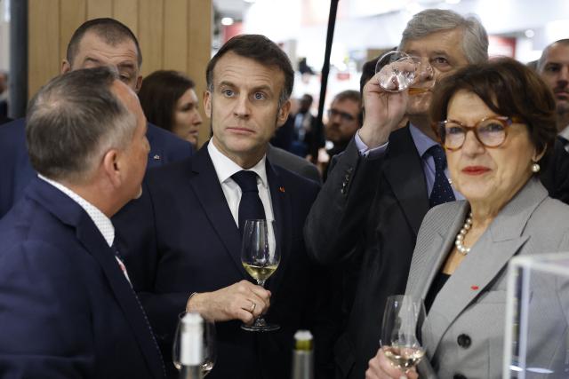 France's President Emmanuel Macron and Agriculture Minister Annie Genevard (R) visit the Wine Paris 2026 fair at the Porte de Versailles exhibition centre in Paris on February 9, 2026. (Photo by Yoan VALAT / POOL / AFP)
