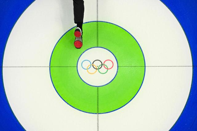 The foot of Norway's Magnus Nedregotten is seen as he slides on the ice during the curling mixed doubles round robin between Norway and South Korea during the Milano Cortina 2026 Winter Olympic Games at the Cortina Curling Olympic Stadium in Cortina d’Ampezzo on February 9, 2026. (Photo by Odd ANDERSEN / AFP)