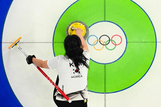 South Korea's Kim Seonyeong competes in the curling mixed doubles round robin between Norway and South Korea during the Milano Cortina 2026 Winter Olympic Games at the Cortina Curling Olympic Stadium in Cortina d’Ampezzo on February 9, 2026. (Photo by Odd ANDERSEN / AFP)