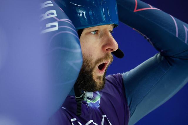 Britain's Marcus Wyatt reacts as he puts his helmet on prior to take part in the skeleton men's training session at Cortina Sliding Centre during the Milano Cortina 2026 Winter Olympic Games in Cortina d'Ampezzo on February 9, 2026. (Photo by FRANCK FIFE / AFP)