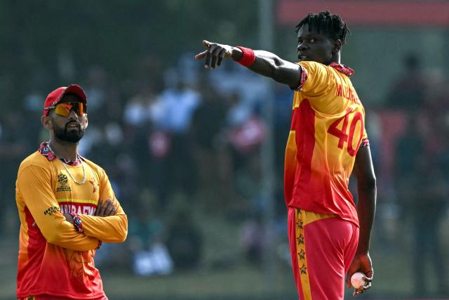 Zimbabwe's captain Sikandar Raza (L) speaks with teammate Blessing Muzarabani during the 2026 ICC Men's T20 Cricket World Cup group stage match between Zimbabwe and Oman at the Sinhalese Sports Club Ground in Colombo on February 9, 2026. (Photo by Ishara S. KODIKARA / AFP)
