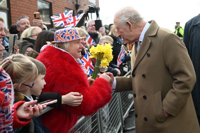 Britain's King Charles III chats with members of the public outside Clitheroe Station during a visit to the town of Clitheroe, northern England on February 9, 2026. (Photo by Paul ELLIS / POOL / AFP)