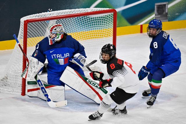 Italy's #01 Gabriella Frances Durante (L) and Italy's #08 Anna Caumo (R) vie with Japan's #08 Akane Hosoyamada during the women's preliminary round Group B Ice Hockey match between Japan and Italy at the Milano Rho Ice Hockey Arena at the Milano Cortina 2026 Winter Olympic Games in Milan, on February 9, 2026. (Photo by Alexander NEMENOV / AFP)