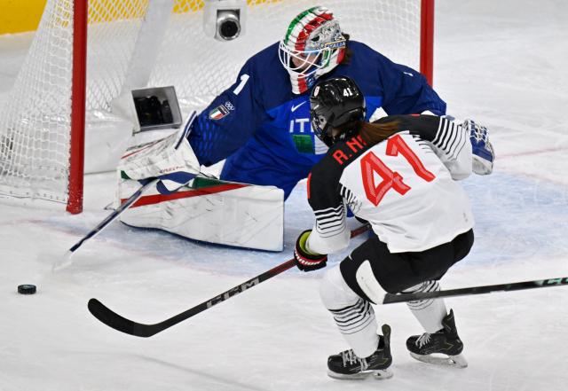 Japan's #41 Riri Noro (R) and Italy's #01 Gabriella Frances Durante vie for the puck during the women's preliminary round Group B Ice Hockey match between Japan and Italy at the Milano Rho Ice Hockey Arena at the Milano Cortina 2026 Winter Olympic Games in Milan, on February 9, 2026. (Photo by Alexander NEMENOV / AFP)