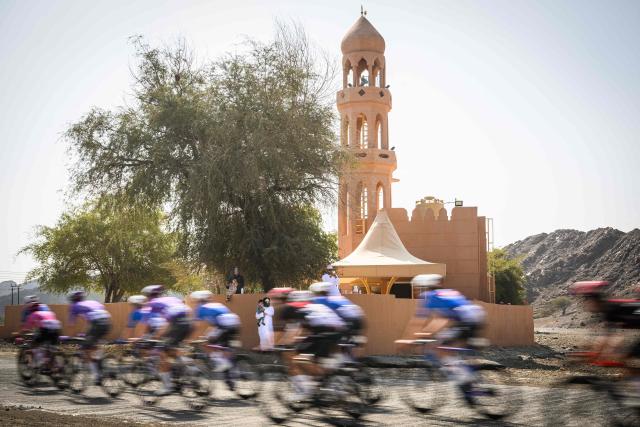 The pack rides during the 3rd stage of the Tour of Oman cycling race from Samail "Al Fayhaa Resthouse" to Misfat Al Abriyeen, on February 9, 2026. (Photo by Loic VENANCE / AFP)