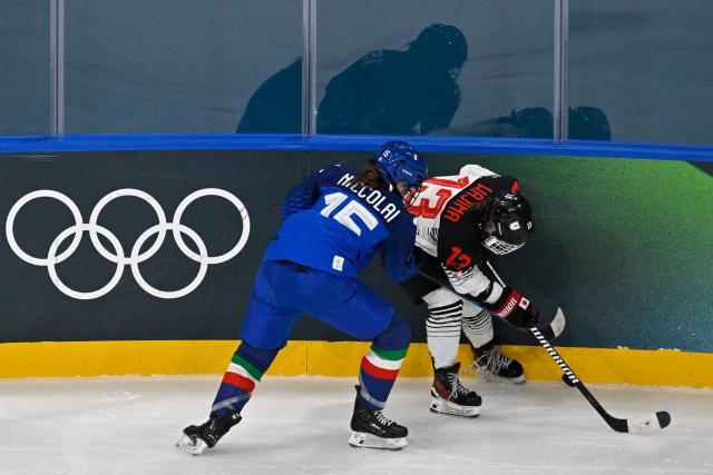 Japan's #13 Yumeka Wajima (R) and Italy's #15 Greta Niccolai vie for the puck during the women's preliminary round Group B Ice Hockey match between Japan and Italy at the Milano Rho Ice Hockey Arena at the Milano Cortina 2026 Winter Olympic Games in Milan, on February 9, 2026. (Photo by Alexander NEMENOV / AFP)
