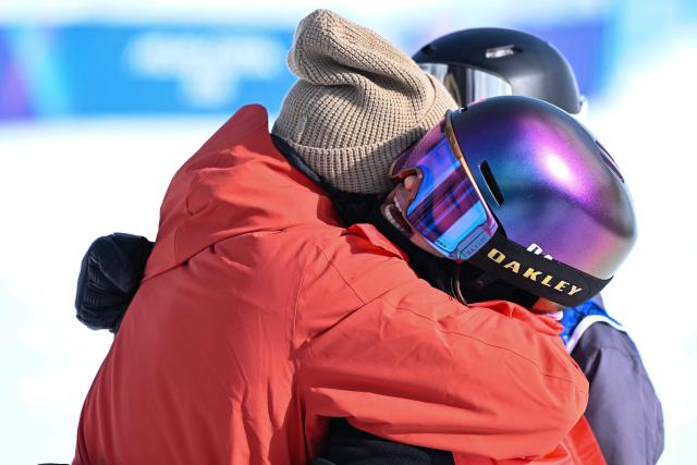 Switzerland's Mathilde Gremaud (R) is congratluated after winning the freestyle skiing women's freeski slopestyle final during the Milano Cortina 2026 Winter Olympic Games at Livigno Snow Park-Slopestyle, in Livigno (Valtellina), on February 9, 2026. (Photo by Kirill KUDRYAVTSEV / AFP)
