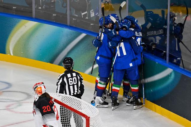 Italy's players celebrate after Italy's #19 Kristin Della Rovere scored the 1-3 goal during the women's preliminary round Group B Ice Hockey match between Japan and Italy at the Milano Rho Ice Hockey Arena at the Milano Cortina 2026 Winter Olympic Games in Milan, on February 9, 2026. (Photo by Alexander NEMENOV / AFP)