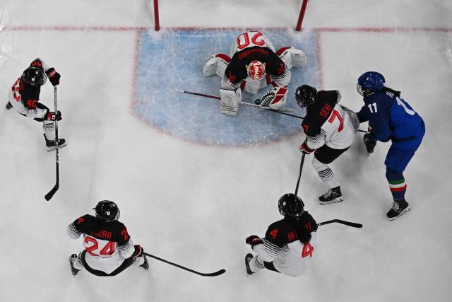 Japan's #20 Miyuu Masuhara defends the goal against Italy's #11 Justine Reyes during the women's preliminary round Group B Ice Hockey match between Japan and Italy at the Milano Rho Ice Hockey Arena at the Milano Cortina 2026 Winter Olympic Games in Milan, on February 9, 2026. (Photo by Alexander NEMENOV / AFP)