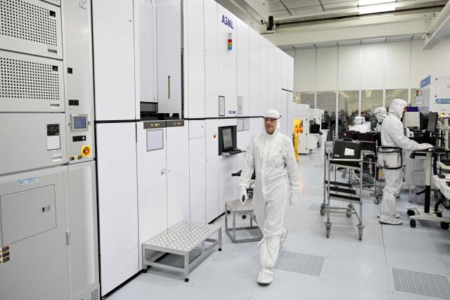 This photograph taken on February 9, 2026, shows a technician walking through the new NanoIC pilot line in the IMEC research and development center for nanoelectronics and digital technologies during his inauguration in Leuven. (Photo by DIRK WAEM / Belga / AFP) / Belgium OUT