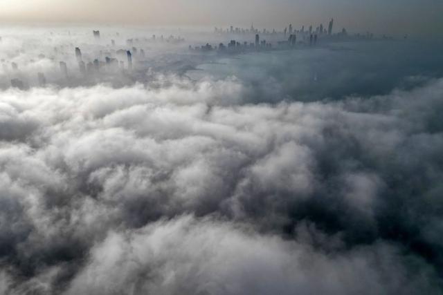 TOPSHOT - Buildings are seen through a veil of fog rolling over al-Salmeyya district in Kuwait City on February 9, 2026. (Photo by Yasser Al-Zayyat / AFP)