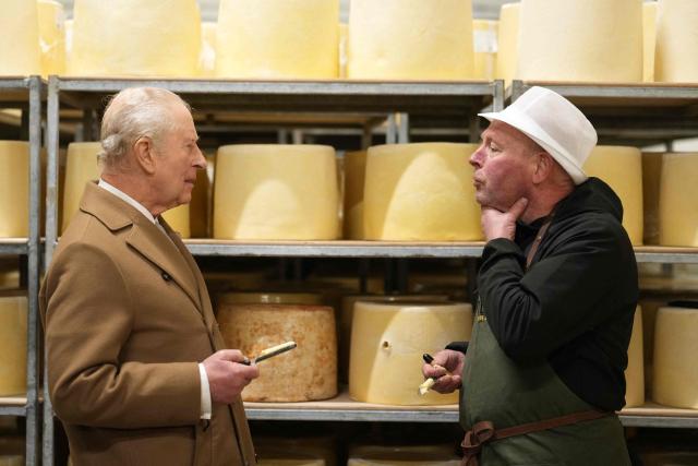 Britain's King Charles III (R) speaks with Head Cheese Grader Bill Yates (L) as he takes a tour of Butlers Dairy in Inglewhite, near Preston, north-west England on February 9, 2026, to mark the opening of new facilities following a fire in 2023. (Photo by Jon Super / POOL / AFP)