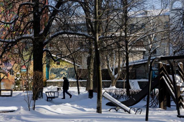 A pedestrian walks through a snow-covered park in Kyiv on February 9, 2026, amid the Russian invasion of Ukraine. (Photo by Tetiana DZHAFAROVA / AFP)