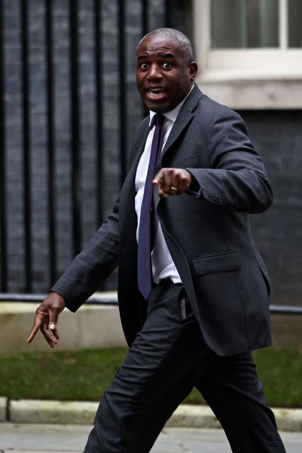 Britain's Justice Secretary and deputy Prime Minister David Lammy gestures to members of the media as he strides towards 10 Downing Street, the official residence of Britain's Prime Minister, presently Labour party leader Keir Starmer, in central London on February 9, 2026. British Prime Minister Keir Starmer "is concentrating on the job in hand" and will not resign, his official spokesman said February 9, as the embattled leader faces intense pressure over the Epstein scandal. Starmer was "getting on with the job of delivering change across the country", the spokesman told reporters, hours after the prime minister's communications chief and chief of staff both resigned. (Photo by Henry NICHOLLS / AFP)