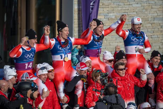 Gold medallists Switzerland's Franjo von Allmen and Switzerland's Tanguy Nef (L)and tied  silver medallists Switzerland's Marco Odermatt and Switzerland's Loic Meillard (R) celebrate after the   men's team combined alpine skiing event during the Milano Cortina 2026 Winter Olympic Games at the Stelvio Ski Centre in Bormio (Valtellina) on February 9, 2026. (Photo by Fabrice COFFRINI / AFP)