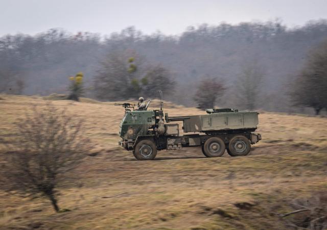 Romanian soldiers operate a High Mobility Artillery Rocket System (HIMARS) launcher during the Dynamic Front 26 military exercise at the Cincu Training Area in Cincu, Romania, on February 9, 2026. Dynamic Front 26 is the largest U.S. Army-led artillery exercise ever conducted in Europe, bringing together NATO allies to rehearse the Eastern Flank Deterrence Line through high-tech coordination across land, air, sea, and cyber domains. The exercise tests the speed of decision-making and cross-border strike capabilities through live-fire drills. Dynamic Front 26 runs from January 26 to February 13, 2026. (Photo by Daniel MIHAILESCU / AFP)