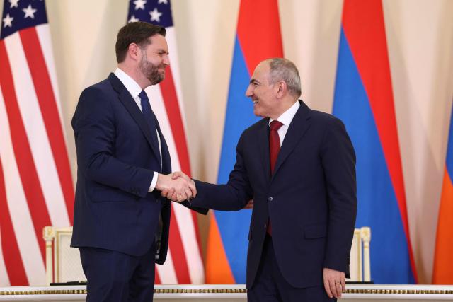 U.S. Vice President JD Vance (L) and Armenian Prime Minister Nikol Pashinyan (R) shake hands at the end of a press conference following their meeting in Yerevan on February 9, 2026. US Vice President JD Vance is due to kick off a visit to Armenia on February 9, 2026 before travelling to Azerbaijan the next day, US officials said, as Washington seeks to consolidate a US-brokered peace process between the neighbours. (Photo by Kevin Lamarque / AFP)