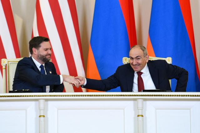 Armenian Prime Minister Nikol Pashinyan and US Vice President JD Vance attend a signing ceremony following their talks in Yerevan on February 9, 2026. (Photo by KAREN MINASYAN / AFP)