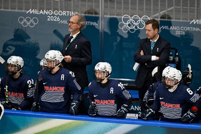 France's head coach Gregory Tarle (back R) and players look on during the women's preliminary round Group B Ice Hockey match between Germany and France at the Milano Rho Ice Hockey Arena at the Milano Cortina 2026 Winter Olympic Games in Milan, on February 9, 2026. (Photo by Alexander NEMENOV / AFP)