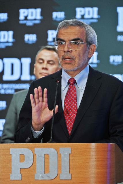 Chile's Public Security Minister Luis Cordero gestures as he speaks during a press conference on the arrest of 20 members of the transnational criminal gang "Los Pulpos" in Santiago on February 9, 2026. (Photo by Rodrigo ARANGUA / AFP)