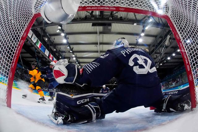 Germany's #09 Svenja Voigt (L) fights with France's #05 Gabrielle De Serres (2nd L) during the women's preliminary round Group B Ice Hockey match between Germany and France at the Milano Rho Ice Hockey Arena at the Milano Cortina 2026 Winter Olympic Games in Milan, on February 9, 2026. (Photo by Darko Bandic / POOL / AFP)