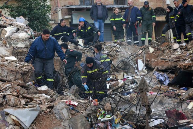Lebanese civil defense and rescue workers search for survivors on February 9, 2026, in the rubble of an old residential building that collapsed in the Bab al-Tabbaneh neighborhood of Tripoli a day earlier. The death toll in a building collapse in the northern Lebanese city of Tripoli rose to 14 after search and rescue operations ended, the civil defence chief said on February 9. (Photo by Anwar AMRO / AFP)