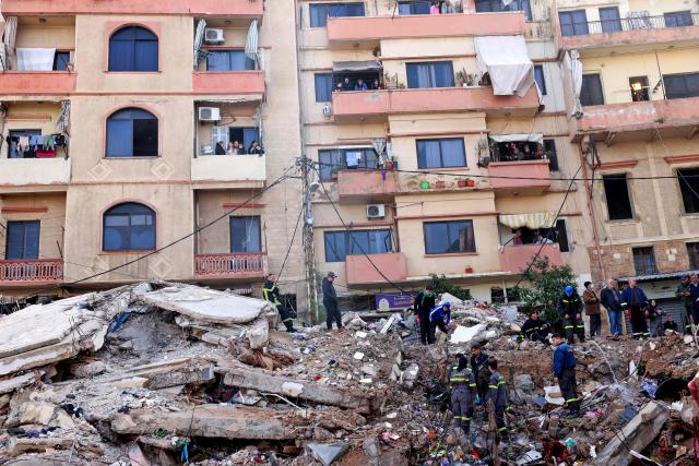 Lebanese civil defense and rescue workers search for survivors on February 9, 2026, in the rubble of an old residential building that collapsed in the Bab al-Tabbaneh neighborhood of Tripoli a day earlier. The death toll in a building collapse in the northern Lebanese city of Tripoli rose to 14 after search and rescue operations ended, the civil defence chief said on February 9. (Photo by Anwar AMRO / AFP)