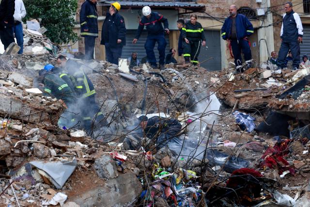 Lebanese civil defense and rescue workers search for survivors on February 9, 2026, in the rubble of an old residential building that collapsed in the Bab al-Tabbaneh neighborhood of Tripoli a day earlier. The death toll in a building collapse in the northern Lebanese city of Tripoli rose to 14 after search and rescue operations ended, the civil defence chief said on February 9. (Photo by Anwar AMRO / AFP)