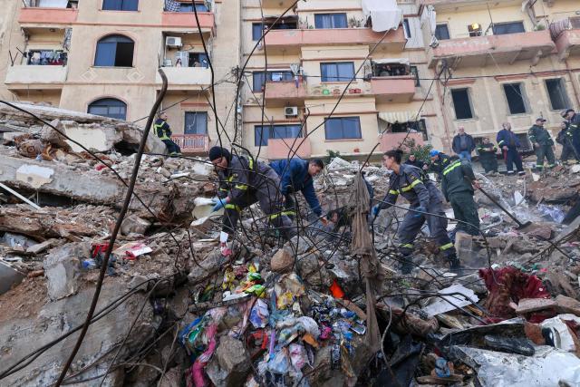 Lebanese civil defense and rescue workers search for survivors on February 9, 2026, in the rubble of an old residential building that collapsed in the Bab al-Tabbaneh neighborhood of Tripoli a day earlier. The death toll in a building collapse in the northern Lebanese city of Tripoli rose to 14 after search and rescue operations ended, the civil defence chief said on February 9. (Photo by Anwar AMRO / AFP)