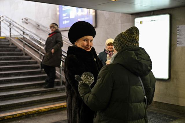 People are seen at the entrance of a metro station in central Moscow on February 9, 2026. (Photo by Hector RETAMAL / AFP)