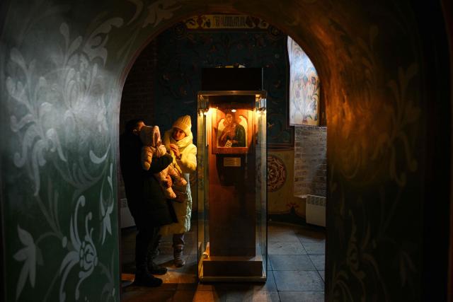 People visit St. Basil's cathedral in central Moscow on February 9, 2026. (Photo by Hector RETAMAL / AFP)