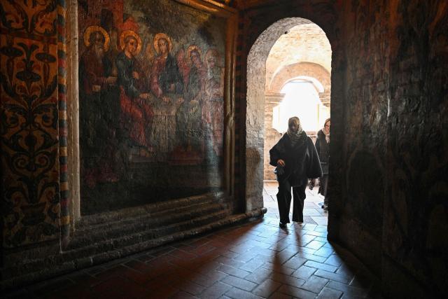 People visit St. Basil's cathedral in central Moscow on February 9, 2026. (Photo by Hector RETAMAL / AFP)