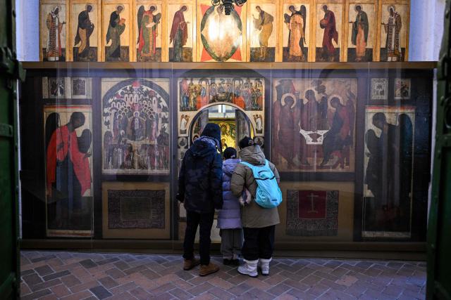 People visit St. Basil's cathedral in central Moscow on February 9, 2026. (Photo by Hector RETAMAL / AFP)
