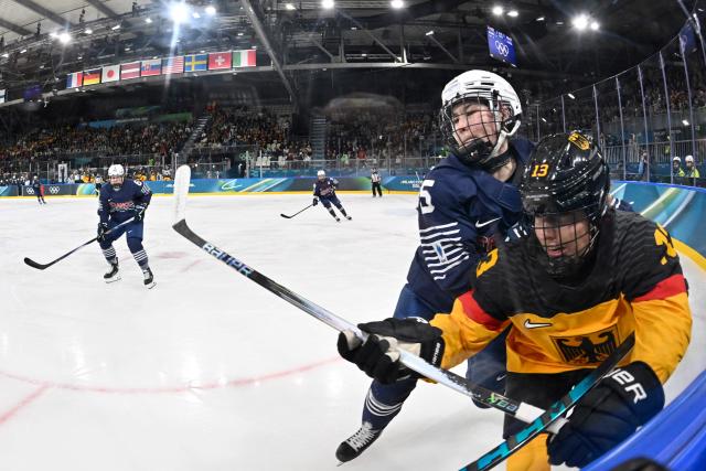 Germany's #13 Luisa Welcke (front) vies with France's #05 Gabrielle De Serres during the women's preliminary round Group B Ice Hockey match between Germany and France at the Milano Rho Ice Hockey Arena at the Milano Cortina 2026 Winter Olympic Games in Milan, on February 9, 2026. (Photo by Alexander NEMENOV / AFP)