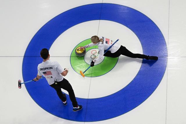 US' Cory Thiesse and US' Korey Dropkin compete in the curling mixed doubles round robin semi-final between USA and Italy during the Milano Cortina 2026 Winter Olympic Games at the Cortina Curling Olympic Stadium in Cortina d’Ampezzo on February 9, 2026. (Photo by Franзois-Xavier MARIT / AFP)