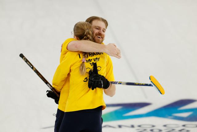 Sweden's Isabella Wranaa and Sweden's Rasmus Wrana celebrates at the end of the curling mixed doubles round robin semi-final between Great Britain and Sweden during the Milano Cortina 2026 Winter Olympic Games at the Cortina Curling Olympic Stadium in Cortina d’Ampezzo on February 9, 2026. (Photo by Odd ANDERSEN / AFP)