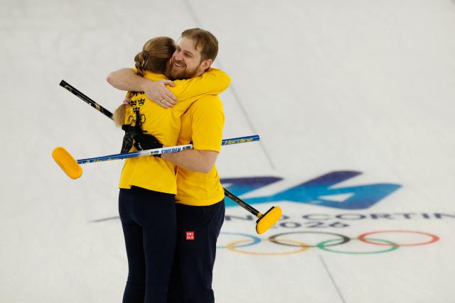 Sweden's Isabella Wranaa and Sweden's Rasmus Wrana celebrates at the end of the curling mixed doubles round robin semi-final between Great Britain and Sweden during the Milano Cortina 2026 Winter Olympic Games at the Cortina Curling Olympic Stadium in Cortina d’Ampezzo on February 9, 2026. (Photo by Odd ANDERSEN / AFP)