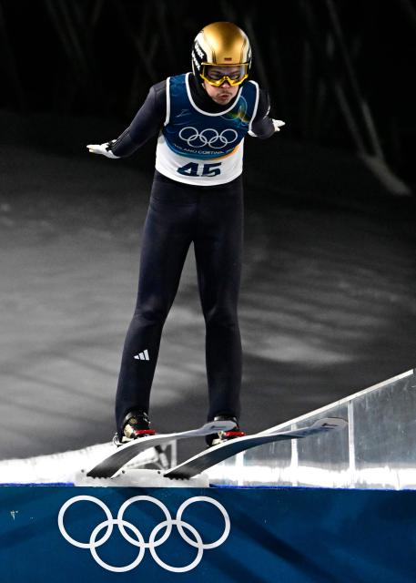 Germany's Philipp Raimund jumps during the men's ski jumping normal hill individual 1st round of the Milano Cortina 2026 Winter Olympic Games at Predazzo Ski Jumping Stadium in Predazzo (Val di Fiemme), on February 9, 2026. (Photo by Tobias SCHWARZ / AFP)