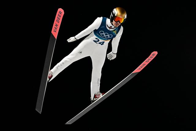 Switzerland's Sandro Hauswirth jumps during the men's ski jumping normal hill individual final round of the Milano Cortina 2026 Winter Olympic Games at Predazzo Ski Jumping Stadium in Predazzo (Val di Fiemme), on February 9, 2026. (Photo by Tobias SCHWARZ / AFP)