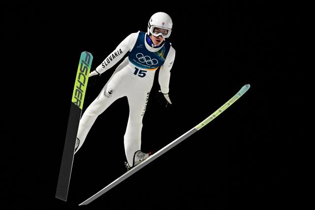 Slovakia's Hektor Kapustik jumps during the men's ski jumping normal hill individual final round of the Milano Cortina 2026 Winter Olympic Games at Predazzo Ski Jumping Stadium in Predazzo (Val di Fiemme), on February 9, 2026. (Photo by Tobias SCHWARZ / AFP)