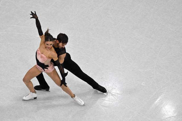 France's Laurence Fournier Beaudry and France's Guillaume Cizeron compete in the figure skating team event ice dance-rhythm dance during the Milano Cortina 2026 Winter Olympic Games at Milano Ice Skating Arena in Milan on February 9, 2026. (Photo by Antonin THUILLIER / AFP)