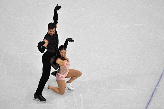 France's Laurence Fournier Beaudry and France's Guillaume Cizeron compete in the figure skating team event ice dance-rhythm dance during the Milano Cortina 2026 Winter Olympic Games at Milano Ice Skating Arena in Milan on February 9, 2026. (Photo by Antonin THUILLIER / AFP)