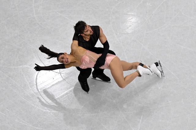 France's Laurence Fournier Beaudry and France's Guillaume Cizeron compete in the figure skating team event ice dance-rhythm dance during the Milano Cortina 2026 Winter Olympic Games at Milano Ice Skating Arena in Milan on February 9, 2026. (Photo by Antonin THUILLIER / AFP)