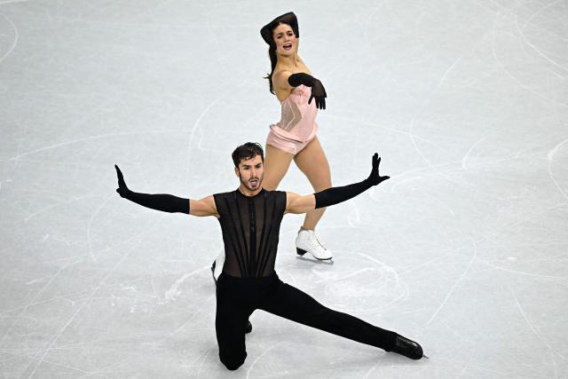 TOPSHOT - France's Laurence Fournier Beaudry and France's Guillaume Cizeron compete in the figure skating team event ice dance-rhythm dance during the Milano Cortina 2026 Winter Olympic Games at Milano Ice Skating Arena in Milan on February 9, 2026. (Photo by Gabriel BOUYS / AFP)