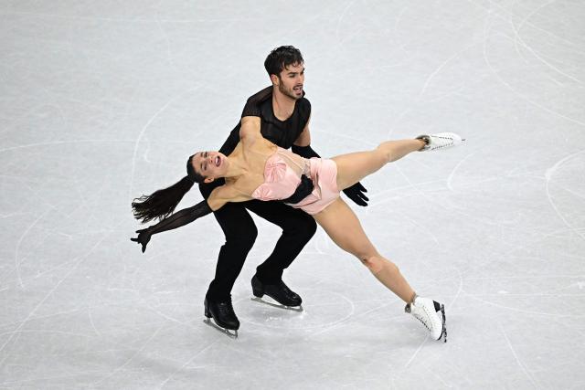 France's Laurence Fournier Beaudry and France's Guillaume Cizeron compete in the figure skating team event ice dance-rhythm dance during the Milano Cortina 2026 Winter Olympic Games at Milano Ice Skating Arena in Milan on February 9, 2026. (Photo by Gabriel BOUYS / AFP)