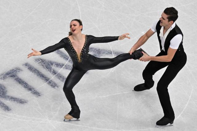Canada's Marie-Jade Lauriault and Canada's Romain Le Gac compete in the figure skating team event ice dance-rhythm dance during the Milano Cortina 2026 Winter Olympic Games at Milano Ice Skating Arena in Milan on February 9, 2026. (Photo by Antonin THUILLIER / AFP)