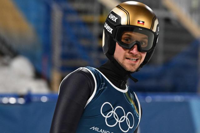 Germany's Felix Hoffmann reacts in the finish area after jumping during the men's ski jumping normal hill individual final round of the Milano Cortina 2026 Winter Olympic Games at Predazzo Ski Jumping Stadium in Predazzo (Val di Fiemme), on February 9, 2026. (Photo by Javier SORIANO / AFP)