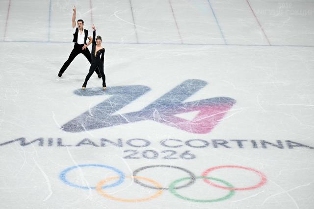 Canada's Marie-Jade Lauriault and Canada's Romain Le Gac compete in the figure skating team event ice dance-rhythm dance during the Milano Cortina 2026 Winter Olympic Games at Milano Ice Skating Arena in Milan on February 9, 2026. (Photo by Gabriel BOUYS / AFP)